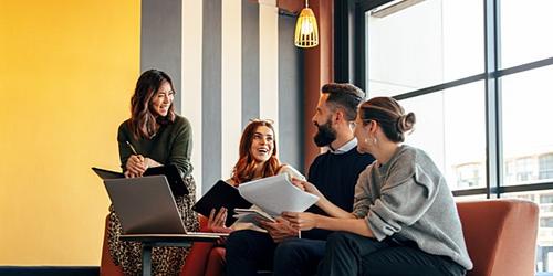 group of employees chatting in an office